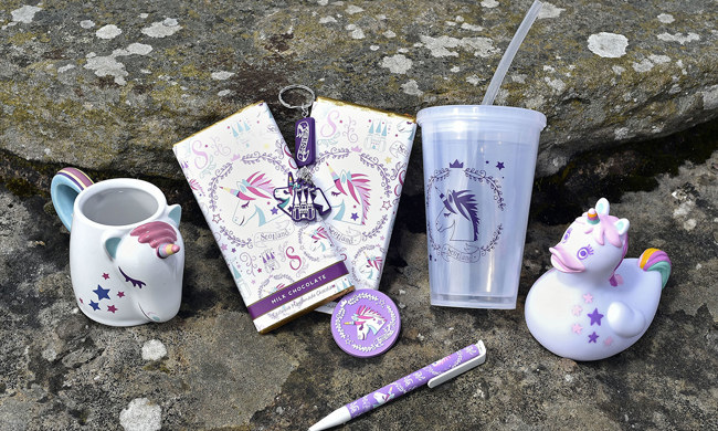 A selection of products from our Unicorn gift range, including a mug, pen, chocolate, reusable cup & keyring