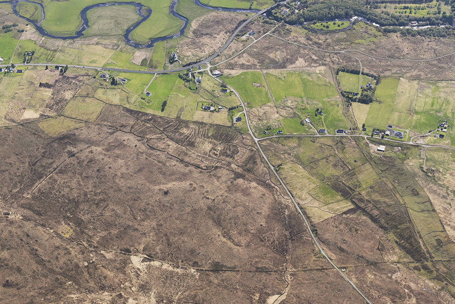 An aerial photograph of a small town and large fields.