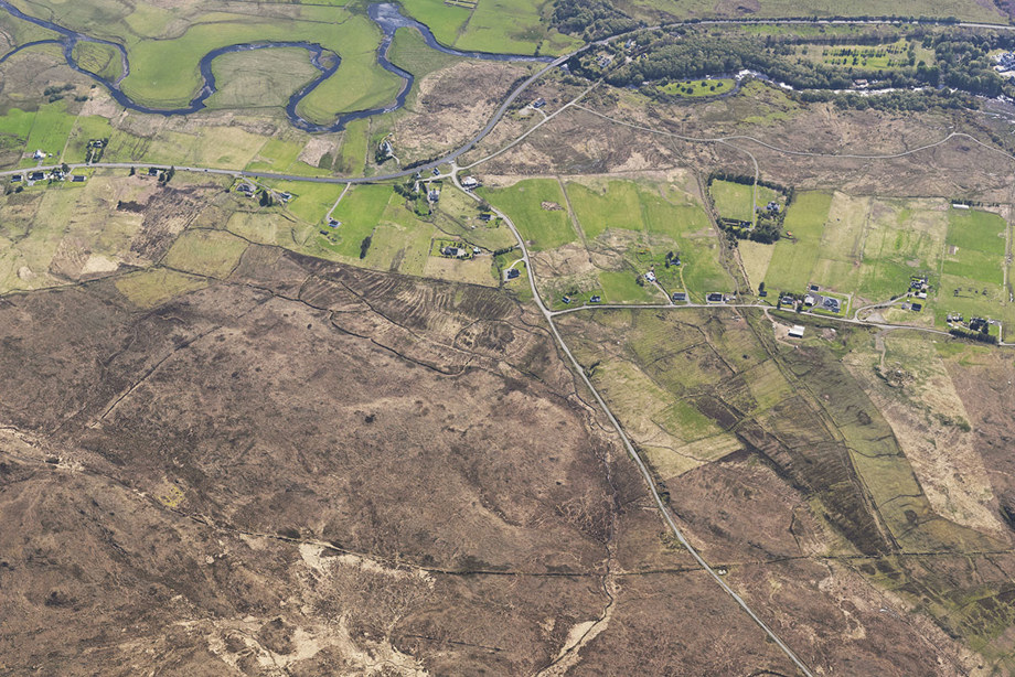An aerial photograph of a small town and large fields.