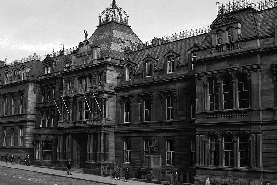 A grand building with an imposing entrance and decorative roof.