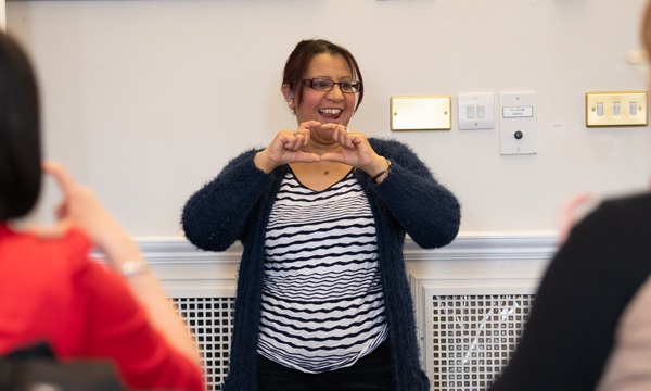a woman delivers a British Sign Language class to HES staff
