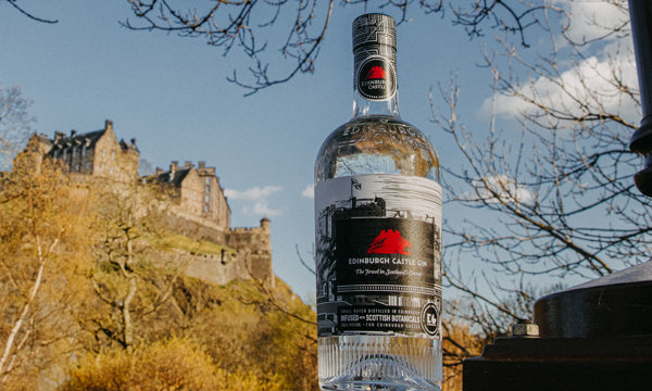 Bottle of Edinburgh Castle Gin with a view of Edinburgh Castle in the background