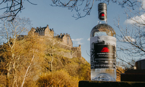 Bottle of Edinburgh Castle Gin with a view of Edinburgh Castle in the background