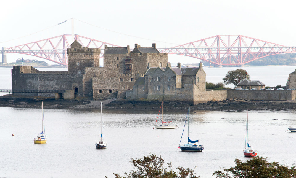 General view of Blackness Castle with Forth Rail Bridge in background