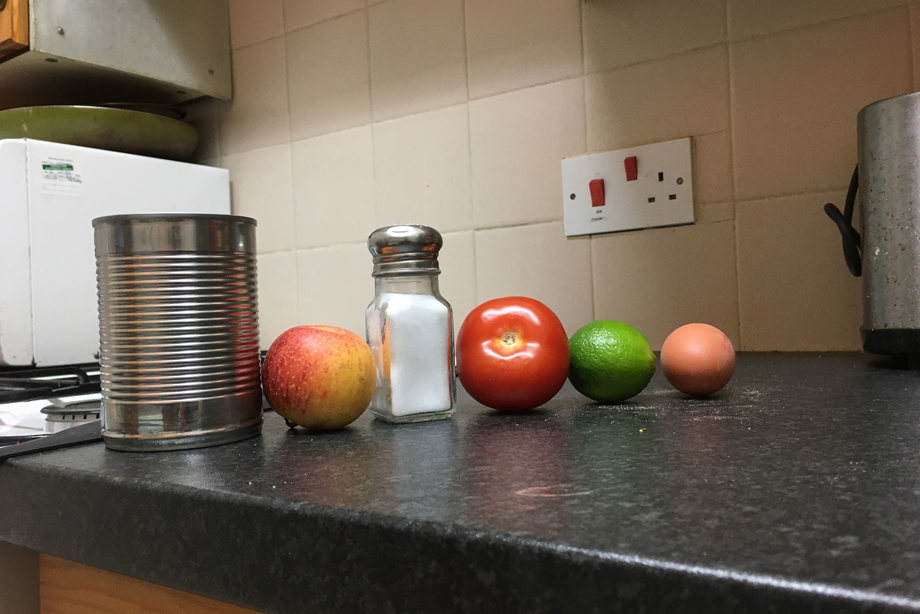 Image of a can, apple, salt, tomato, lime and egg, which spells out castle