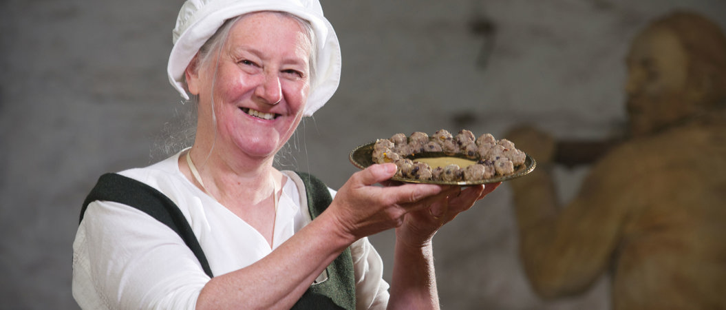 Costumed performer dressed as a cook in the Great Kitchens at Stirling Castle