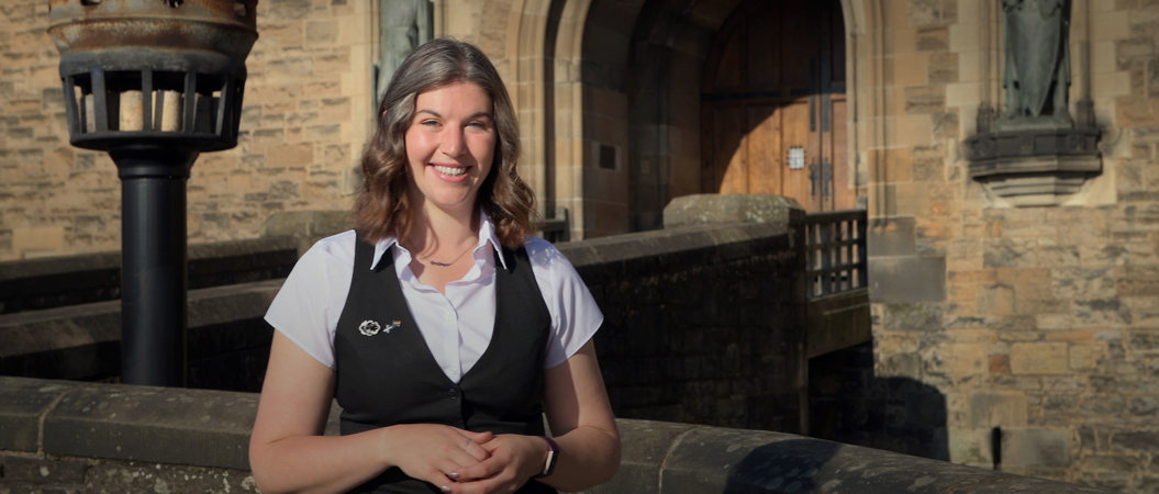 Member of the Edinburgh Castle team standing in front of the castle