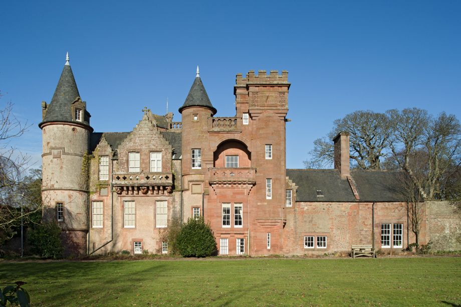 A large red sandstone building with turrets