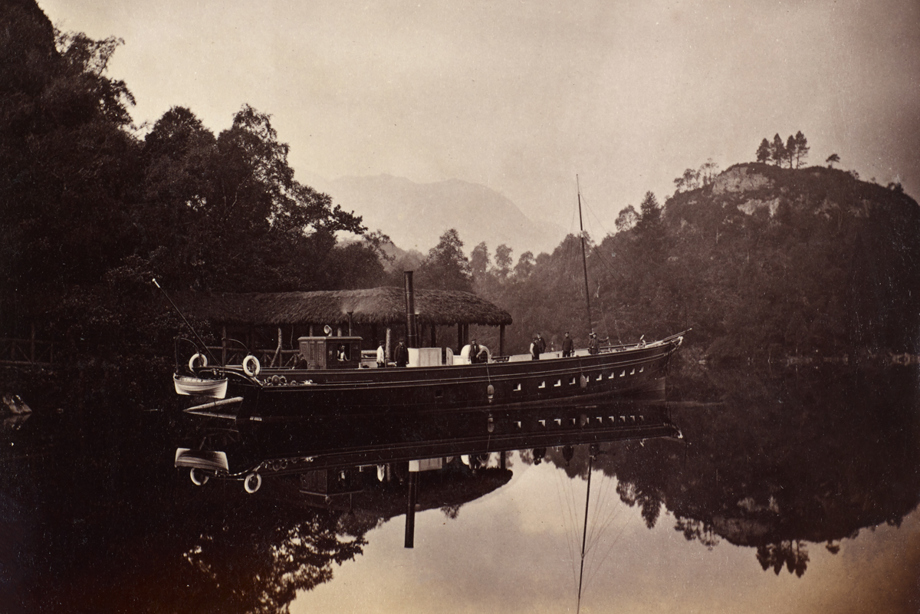 Boat on a loch surrounded by trees