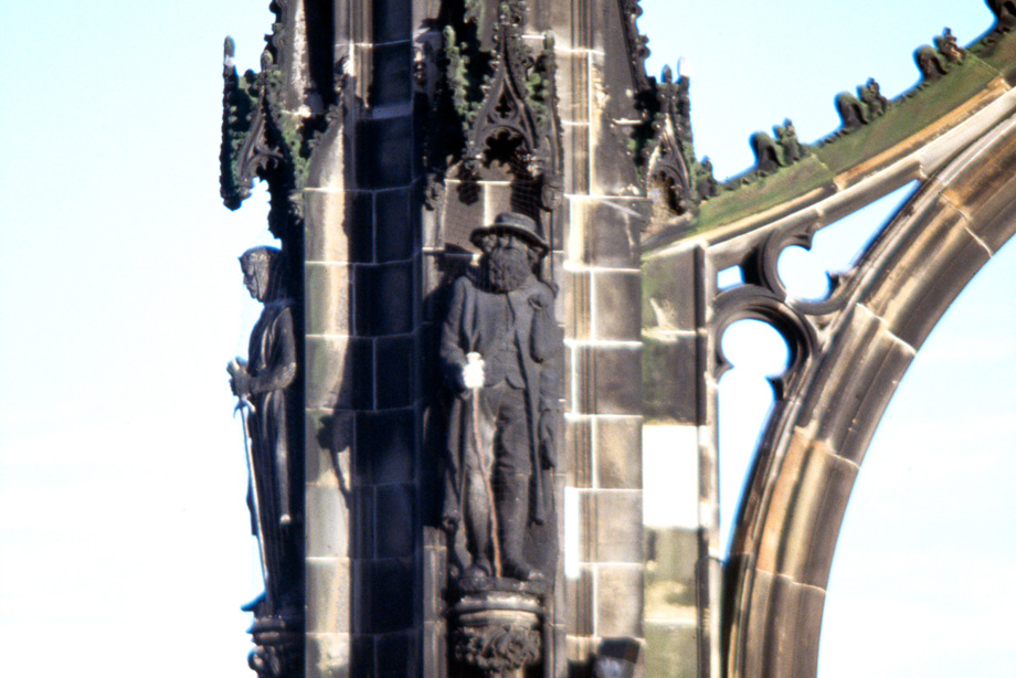 Statues on the side of a monument of two men, one wearing armour and another with a long beard and a walking stick