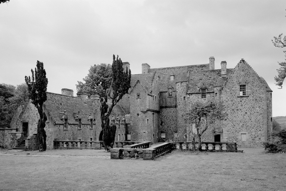 A Scots Baronial building with turreted towers and crow stepped gables 