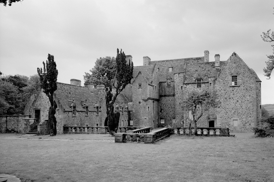 A Scots Baronial building with turreted towers and crow stepped gables 
