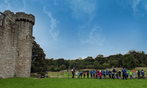 Image of group standing in the distance outside Craigmillar Castle