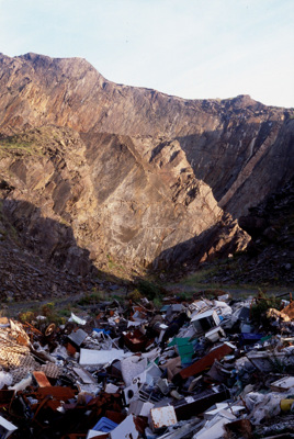 A pile of rubbish within the steep walls of a quarry