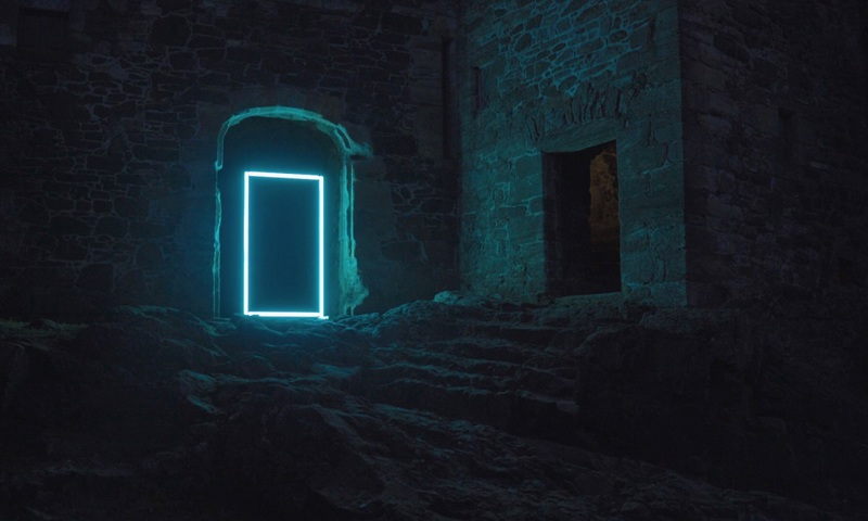 A blue rectangle being projected onto a doorway within the dark ruins of castle