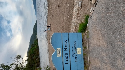 A sign of "Loch Ness" in front of the shores of the water