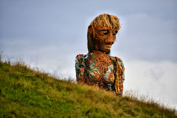 A giant model of a woman over a hill