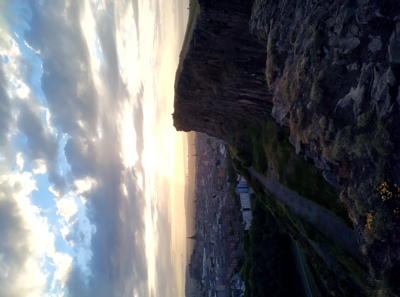 A photograph of the crags at sunrise on the edge looking over Edinburgh