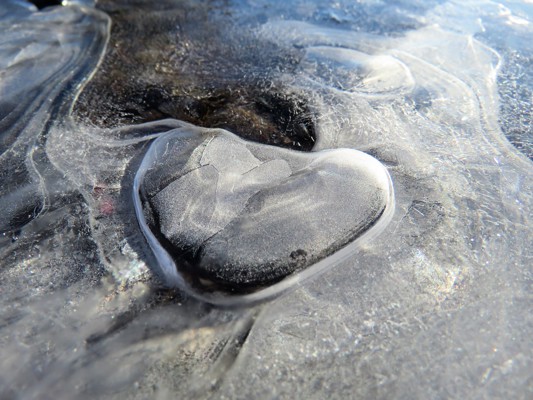 Frozen ice with heart shaped stone and swirls.  