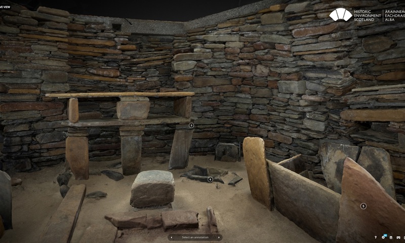 a 3D image of the inside of one of the houses at Skara Brae, with drystone walls and shelves and beds made of stone slabs