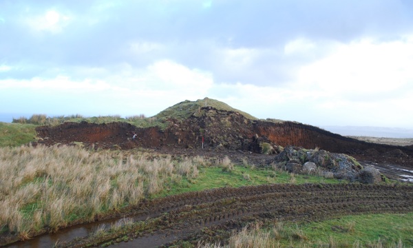 a burial cairn destroyed by excavation and tire tracks around it