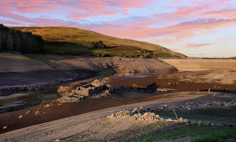 A ruined cottage in a river bed that's drying out