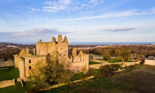 Craigmillar Castle in autumn with blue skies above