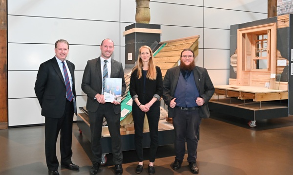 Photo of Alex Paterson, Culture Minister Neil Gray, Emily Tracey and Moses Jenkins holding a copy of the new Green Recovery Statement for Scotland’s historic environment