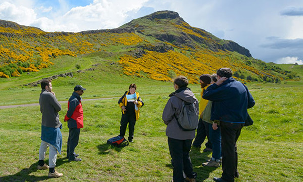 People walking in Holyrood Park with a Ranger
