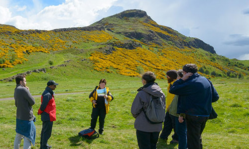 People walking in Holyrood Park with a Ranger