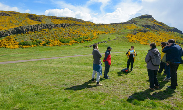 People walking in Holyrood Park with a Ranger