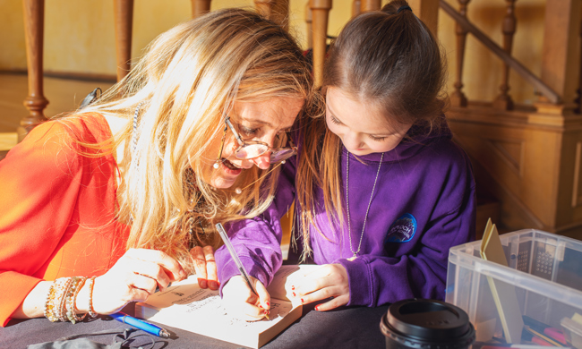 Cressida Cowell helps a child to write a story