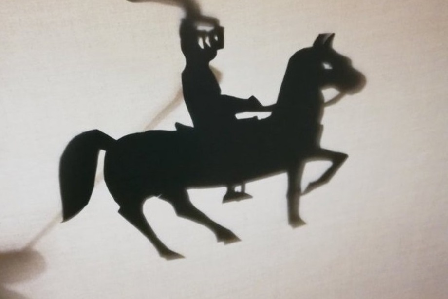 A shadow puppet of a knight on a horse