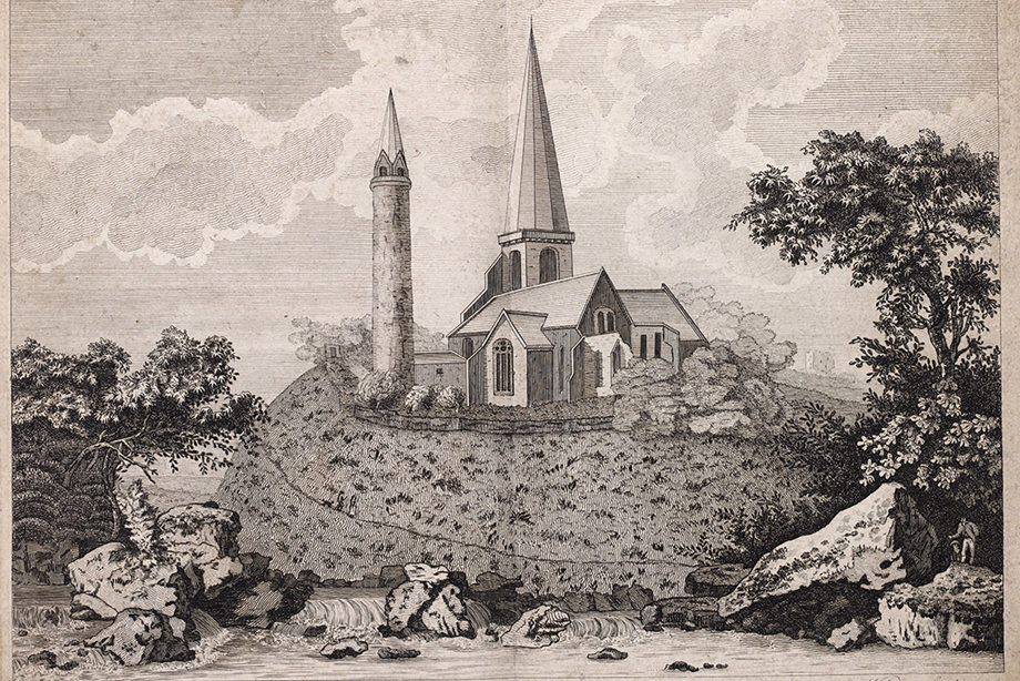 A towering stone cathedral and round tower, on top of a small hill. Image reference number: DP_093978