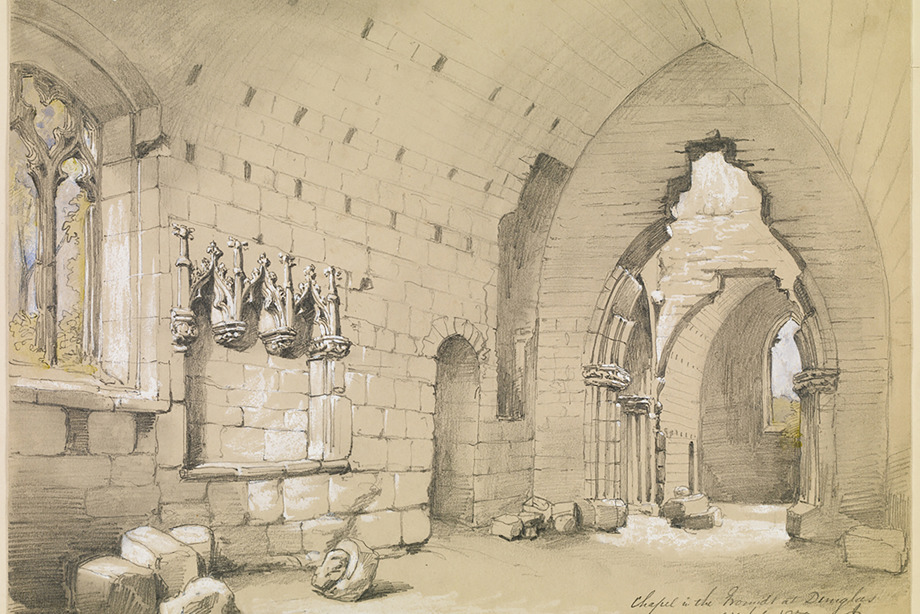 Inside a historic church with a carved entrance archway and carved windows, with loose stones on the floor