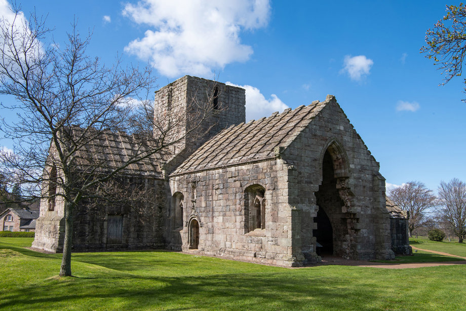 A small stone church with a roof 