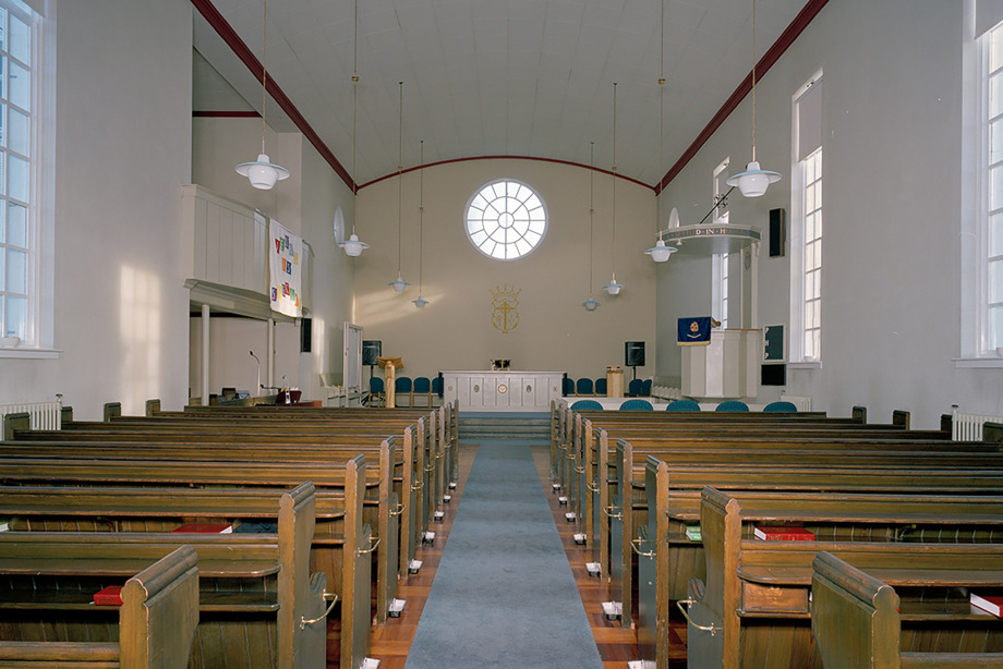 A simple church with white walls and wooden pews. Image reference number:  SC_1375461