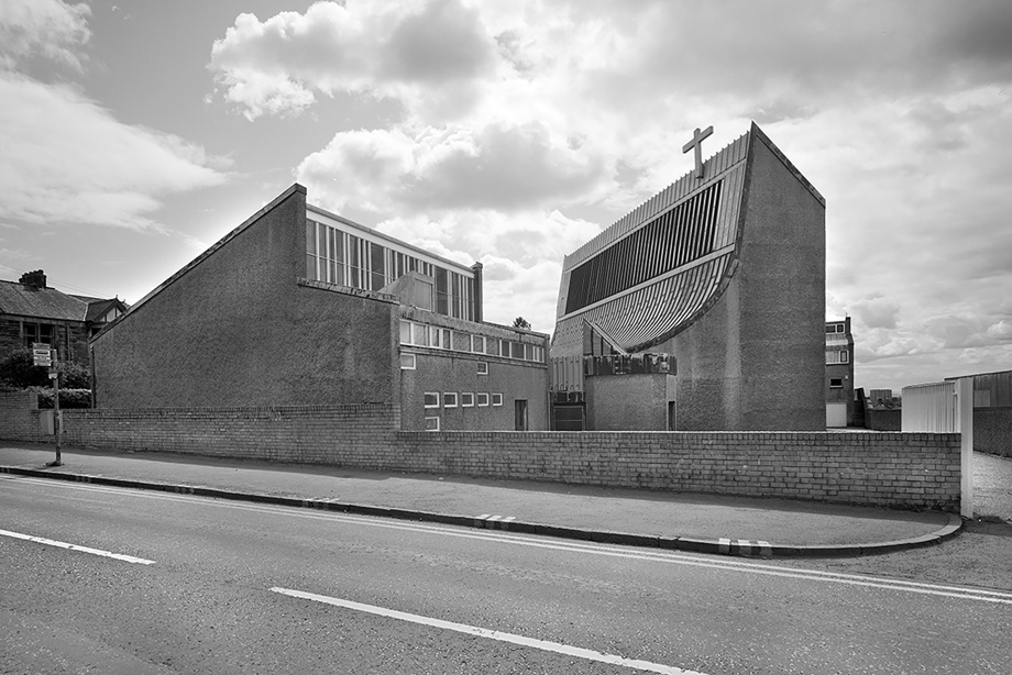 A brutalist / modern looking church with blocky features but one deeply curved wall. Image reference number: SC_1062367