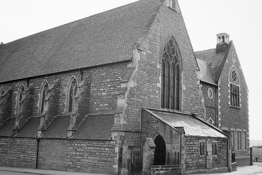 A stone church with a many windows featuring decorative stone carving. Reference no: SC_1653120