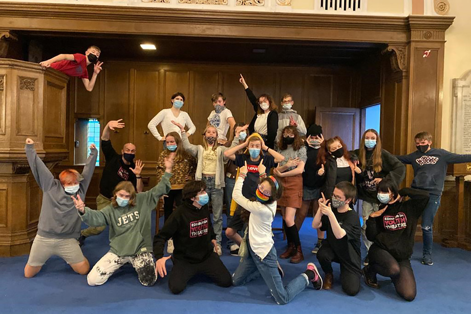 A group of young people posing enthusiastically inside a church