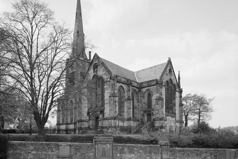A historic stone church with a tall spire. Reference no: SC_1154183