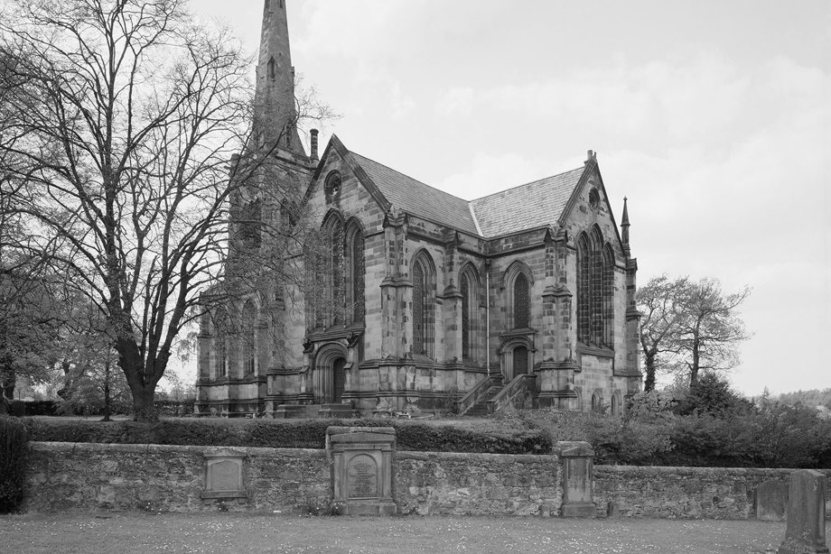 A historic stone church with a tall spire. Reference no: SC_1154183