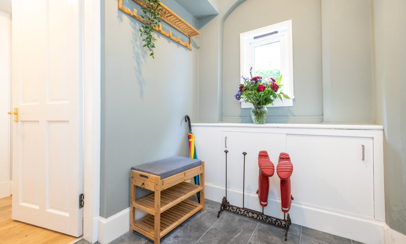 Wellie stand and seat in hallway of Meadowbank Lodge