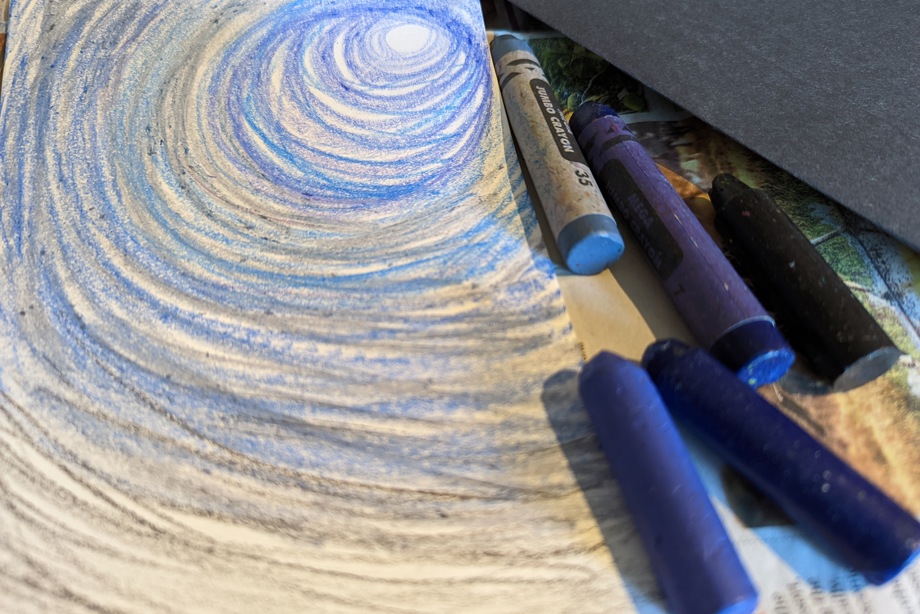 Photo of crayons and a drawing of a moonlit sky created with crayons