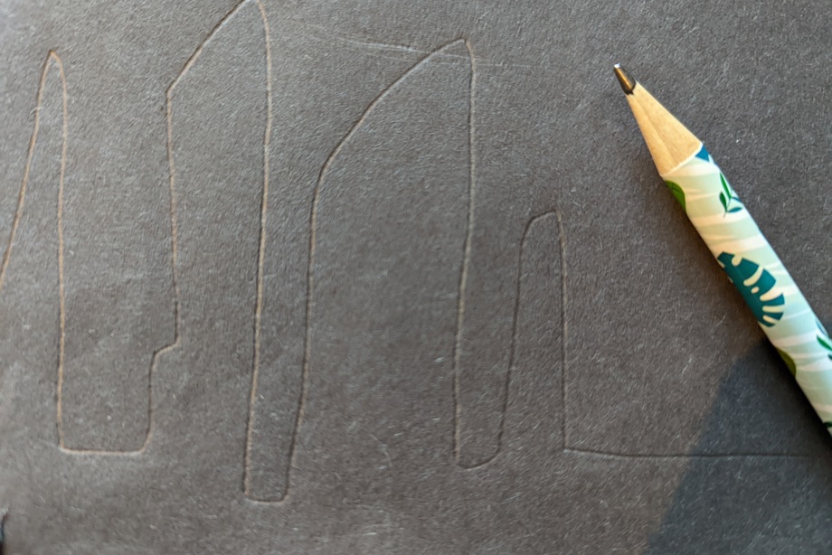 Pencil outline of standing stones on dark paper