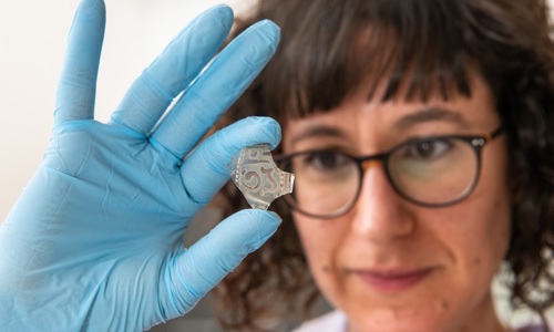 Our Applied Conservation Manager at HES, examines a piece of Islamic glass at the Engine Shed in Stirling.