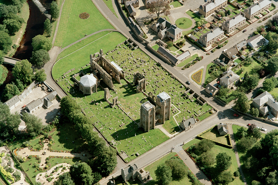 An expansive cathedral ruin, on a large, grassy plot