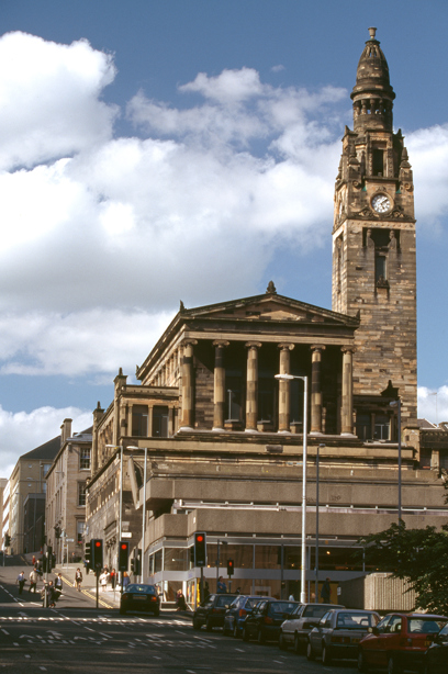 A classical, greek-style stone building with columns, in the city. Image reference number: SC_1528657