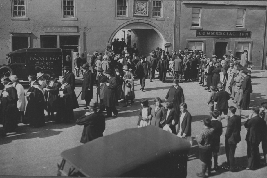 A procession of people on the street celebrating