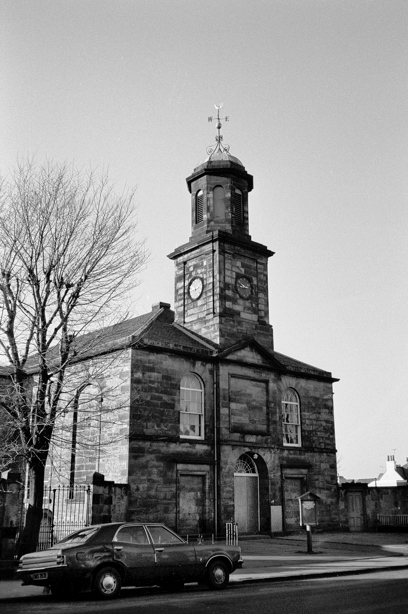 A historic stone church with a central spire. Reference no: SC_584476
